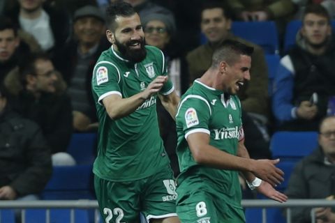 Leganes' Gabriel Appelt, right, celebrates with teammates after scoring his team's second goal against Real Madrid during the Spanish Copa del Rey quarterfinal second leg soccer match between Real Madrid and Leganes at the Santiago Bernabeu stadium in Madrid, Wednesday, Jan. 24, 2018. Leganes won 2-1. (AP Photo/Francisco Seco)