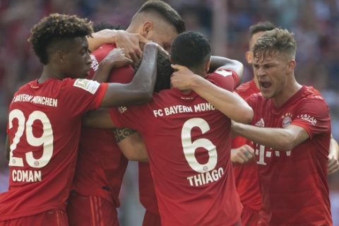 Munich's players celebrate their side's equalizing goal during a German Bundesliga soccer match between Bayern Munich and FSV Mainz 05 in Munich, Germany, Saturday, Aug.31, 2019. (Sven Hoppe/dpa via AP)