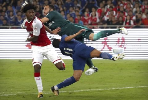 Chelsea's Pedro, foreground, collides with Arsenal goalkeeper David Ospina during the first half of their friendly soccer match in Beijing, Saturday, July 22, 2017. (AP Photo/Mark Schiefelbein)