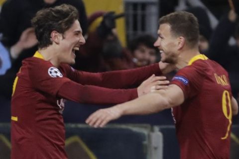 Roma midfielder Nicolo' Zaniolo, left, celebrates after scoring his side's second goal with his teammate Edin Dzeko during a Champions League round of 16 first leg soccer match between Roma and Porto, at Rome's Olympic Stadium, Tuesday, Feb. 12, 2019. (AP Photo/Andrew Medichini)