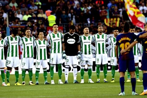 Betis and Barcelona players observe a minute of silence for the victims of the van attacks before a La Liga soccer match between Barcelona and Betis at the Camp Nou stadium in Barcelona, Spain, Sunday, Aug. 20, 2017. Security was stepped up for the match after a terror attack that killed 14 people and wounded over 120 in Barcelona and police put up scores of roadblocks across northeast Spain on Sunday in hopes of capturing a fugitive suspect at large following the vehicle attack. Barcelona players are all wearing shirts with 'Barcelona' on their backs tonight, rather than their names to pay homage to the van attack victims. (AP Photo/Manu Fernandez)