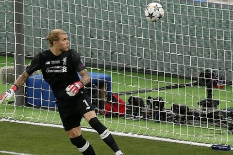 FILE - In this Saturday, May 26, 2018 file photo Liverpool goalkeeper Loris Karius looks at the ball after a fumble allowed Real Madrid's Gareth Bale to score his side's 3rd goal during the Champions League Final soccer match between Real Madrid and Liverpool at the Olimpiyskiy Stadium in Kiev, Ukraine. Doctors based in Boston have concluded Karius sustained a concussion during last month's Champions League final that would have affected his performance. (AP Photo/Darko Vojinovic, File)