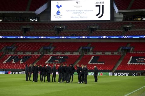 Juventus players stand on the pitch before the press conference at Wembley Stadium, London, Tuesday March 6, 2018. Juventus face Tottenham Hotspur in a Champions League soccer, round of 16, 2nd leg match in London on Wednesday. (Steven Paston/PA via AP)