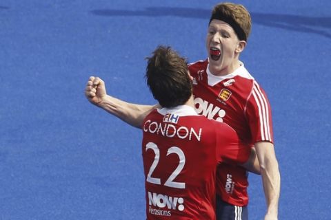 England's Samuel Ward celebrates a goal with teammate David Condon, back to camera during the Champions Trophy Hockey match against Australia in Bhubaneswar, India, Saturday, Dec.6, 2014. (AP Photo/Biswaranjan Rout)