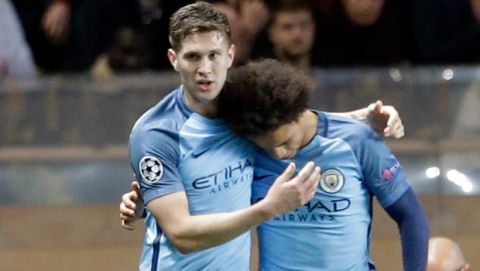 Manchester City's Leroy Sane, center right, is congratulated by Manchester City's John Stones, center left, after scoring his side's first goal with teammates during a Champions League round of 16 second leg soccer match between Monaco and Manchester City at the Louis II stadium in Monaco, Wednesday March 15, 2017. (AP Photo/Claude Paris)