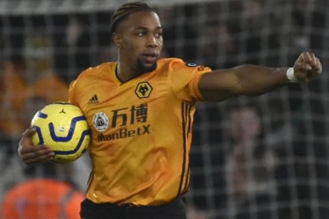 Wolverhampton Wanderers' Adama Traore celebrates after scoring his side's first goal during the English Premier League soccer match between Wolverhampton Wanderers and Manchester City at the Molineux Stadium in Wolverhampton, England, Friday, Dec. 27, 2019. (AP Photo/Rui Vieira)