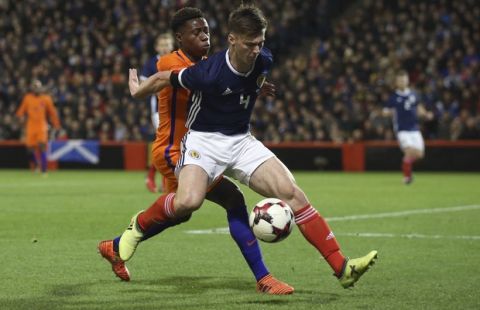 Scotland's Kieran Tierney, right, and Netherlands Quincy Promes during the International Friendly soccer match at Pittodrie, Aberdeen, Scotland, Thursday Nov. 9, 2017. (Andrew Milligan/PA via AP)