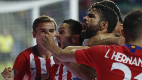 Atletico's Diego Costa, 2nd right celebrates with teammates after scoring his sides first goal during the UEFA Super Cup final soccer match between Real Madrid and Atletico Madrid at the Lillekula Stadium in Tallinn, Estonia, Wednesday, Aug. 15, 2018. (AP Photo/Pavel Golovkin)