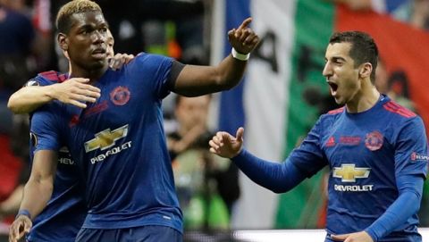 Manchester's Paul Pogba celebrates with his teammates Matteo Darmian and Henrikh Mkhitaryan, right, after scoring the opening goal during the soccer Europa League final between Ajax Amsterdam and Manchester United at the Friends Arena in Stockholm, Sweden, Wednesday, May 24, 2017. (AP Photo/Michael Sohn)