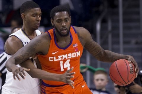 Clemson's Elijah Thomas (14) gets pressure from Notre Dame's Juwan Durham during an NCAA college basketball game Wednesday, March 6, 2019, in South Bend, Ind. Clemson won 64-62. (AP Photo/Robert Franklin)