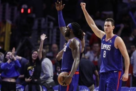 Los Angeles Clippers' Montrezl Harrell, center, and Danilo Gallinari, celebrate after a 112-107 overtime win over the Memphis Grizzlies during an NBA basketball game Friday, Nov. 23, 2018, in Los Angeles. (AP Photo/Marcio Jose Sanchez)