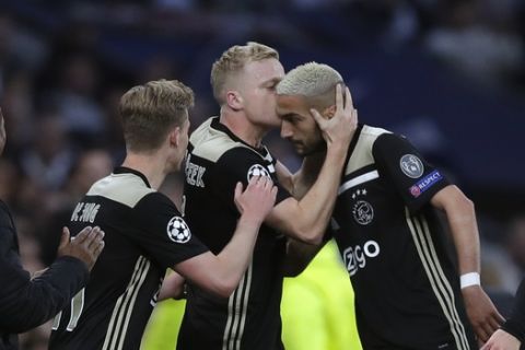 Ajax's Donny van de Beek, center, celebrates with teammates after scoring his side's opening goal during the Champions League semifinal first leg soccer match between Tottenham Hotspur and Ajax at the Tottenham Hotspur stadium in London, Tuesday, April 30, 2019. (AP Photo/Kirsty Wigglesworth)