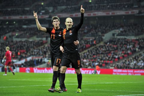 Arjen Robben (R) of The Netherlands celebrates with Klass-Jan Huntelaar (L) after scoring the opening goal of the International friendly football match between England and The Netherlands at Wembley Stadium in London on February 29, 2012. AFP PHOTO/GLYN KIRK

NOT FOR MARKETING OR ADVERTISING USE / RESTRICTED TO EDITORIAL USE (Photo credit should read GLYN KIRK/AFP/Getty Images)
