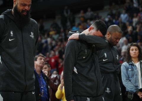 From left to right, Houston Rockets center Tyson Chandler, guard Austin Rivers and forward P.J. Tucker react during a tribute to Kobe Bryant before an NBA basketball game against the Denver Nuggets, Sunday, Jan. 26, 2020, in Denver. Bryant died in a California helicopter crash Sunday. (AP Photo/David Zalubowski)