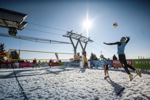In this March 2016 photo released by Chaka2 GmbH, Austria's Michael Leeb, serving, and Florian Schnetzer face off against Poland's Michal Matyja and Rafal Matusiak, far court, during a snow volleyball match in Wagrain-Kleinarl, Austria. The sport's international governing body hopes tournaments from the Alps to the Andes will earn snow volleyball a spot in the Olympics and make volleyball the first sport to be played in both the Winter and Summer Games. (Thomas Leskoschek/Chaka2 GmbH via AP)