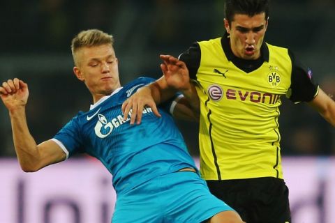 DORTMUND, GERMANY - MARCH 19: Oleg Shatov of Zenit tackles Nuri Sahin of Dortmund during the UEFA Champions League round of 16, second leg match between Borussia Dortmund and FC Zenit at Signal Iduna Park on March 19, 2014 in Dortmund, Germany.  (Photo by Alex Grimm/Bongarts/Getty Images)