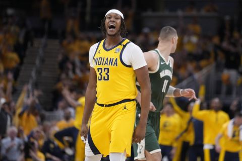 Indiana Pacers center Myles Turner (33) celebrates after a three-point basket against the Milwaukee Bucks during the first half in Game 2 in an NBA basketball first-round playoff series, Friday, April 26, 2024, in Indianapolis. (AP Photo/Michael Conroy)