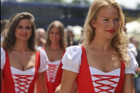 Grid girls walk in the paddock after the third free practice, at the Hungaroring racetrack, in Budapest, Hungary, Saturday, July 23, 2016. The Hungarian Formula One Grand Prix will be held on Sunday July, 24. (AP Photo/Luca Bruno)