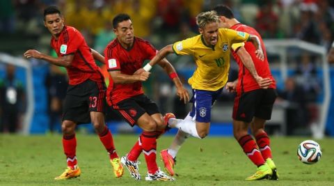 FORTALEZA, BRAZIL - JUNE 17:  Neymar of Brazil is challenged by Jose Juan Vazquez of Mexico, Rafael Marquez and Marco Fabian during the 2014 FIFA World Cup Brazil Group A match between Brazil and Mexico at Castelao on June 17, 2014 in Fortaleza, Brazil.  (Photo by Michael Steele/Getty Images)