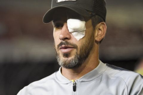 Pablo Perez of Argentina's Boca Juniors, walks on the pitch of the Antonio Vespucio Liberti stadium wearing an eye patch, after the final soccer match of the Copa Libertadores was rescheduled for Sunday, in Buenos Aires, Argentina, Saturday, Nov. 24, 2018. The match was rescheduled after the bus carrying the Boca Juniors players was attacked by River Plate fans, injuring several players including Perez. (AP Photo/Gustavo Garello)