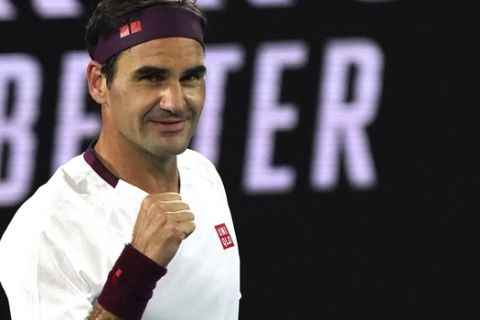 Switzerland's Roger Federer celebrates after defeating Hungary's Marton Fucsovics in their fourth round singles match at the Australian Open tennis championship in Melbourne, Australia, Sunday, Jan. 26, 2020. (AP Photo/Lee Jin-man)