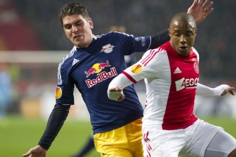 Jonatan Soriano of FC Salzburg, left, and Ajax's Lerin Duarte, right, vies for the ball during their Europa League round of 32  first leg soccer match  between Ajax and FC Salzburg at the ArenA stadium in Amsterdam, Netherlands, Thursday, Feb. 20, 2014. (AP Photo / Patrick Post)