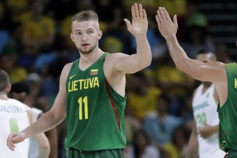 Lithuania's Domantas Sabonis (11) celebrates with teammate Mantas Kalnietis, right, after making a basket during a basketball game against Brazil at the 2016 Summer Olympics in Rio de Janeiro, Brazil, Sunday, Aug. 7, 2016. (AP Photo/Charlie Neibergall)