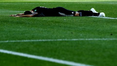 CORRECTS ID - Argentina's Maximiliano Meza lies on the pitch during the group D match between Argentina and Iceland at the 2018 soccer World Cup in the Spartak Stadium in Moscow, Russia, Saturday, June 16, 2018. (AP Photo/Ricardo Mazalan)