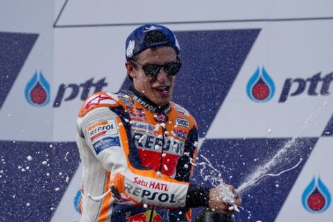 Spain's rider Marc Marquez of the Repsol Honda Team celebrates after winning Thailand's inaugural MotoGP Grand Prix at the Chang International Circuit in Buriram, Thailand, Sunday, Oct. 7, 2018. (AP Photo/Gemunu Amarasinghe)