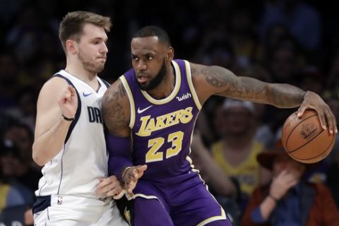Los Angeles Lakers' LeBron James (23) is defended by Dallas Mavericks' Luka Doncic during the first half of an NBA basketball game Wednesday, Oct. 31, 2018, in Los Angeles. (AP Photo/Marcio Jose Sanchez)