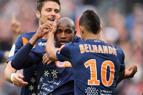 Montpellier's forward Souleymane Camara (C) is congratulates by his teammates Olivier Giroud (L) and Younes Belhanda (R) after scoring a goal during the French L1 football match Montpellier vs Valenciennes, on April 21, 2012 at the Mosson stadium in Montpellier, southern France. AFP PHOTO / PASCAL GUYOT (Photo credit should read PASCAL GUYOT/AFP/Getty Images)