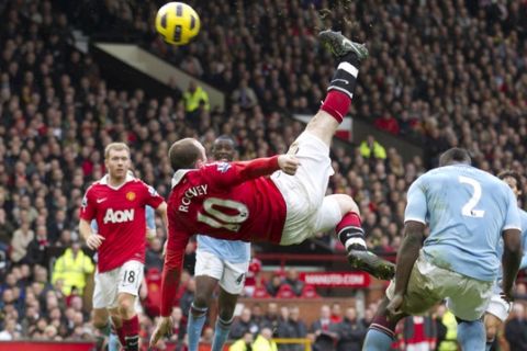 FILE - In this Feb. 12, 2011, file photo, Manchester United's Wayne Rooney, center, scores the game-winning goal with an overhead kick against Manchester City during their English Premier League soccer match at Old Trafford Stadium, Manchester, England. Rooney's fantastic finish is featured on the 10-goal shortlist published by FIFA on Friday, Nov. 18, 2011, competing to be chosen as the best score in 2011. (AP Photo/Jon Super, File)