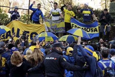 Boca Juniors supporters cheer during a gathering outside the team hotel in Madrid Saturday, Dec. 8, 2018. The Copa Libertadores Final between River Plate and Boca Juniors will be played on Dec. 9 in Madrid, Spain, at Real Madrid's stadium. (AP Photo/Manu Fernandez)