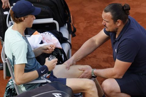 Italy's Jannik Sinner gets medical assistance as he plays Russia's Andrey Rublev during their fourth round match of the French Open tennis tournament at the Roland Garros stadium Monday, May 30, 2022 in Paris. (AP Photo/Jean-Francois Badias)