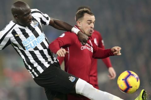 Newcastle's Mohamed Diame, left, and Liverpool's Xherdan Shaqiri vie for the ball during the English Premier League soccer match between Liverpool and Newcastle at Anfield Stadium, Liverpool, England, Wednesday, Dec. 26, 2018. (AP Photo/Jon Super)