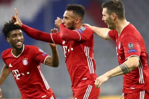 Bayern Munich's Corentin Tolisso, centre, celebrates with teammates after scoring his team's third goal during the Champions League Group A soccer match between Bayern Munich and Atletico Madrid at the Allianz Arena in Munich, Germany, Wednesday, Oct. 21, 2020. (AP Photo/Matthias Schrader,Pool)