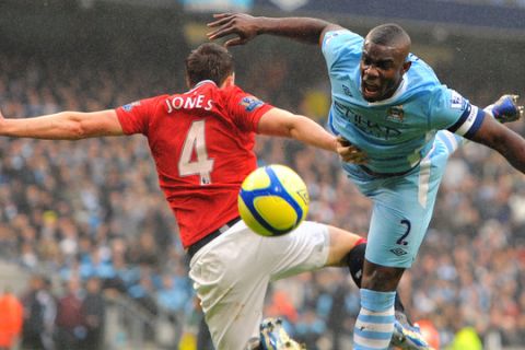 Manchester City's English defender Micah Richards (R) contests a high ball with Manchester United's English defender Phil Jones (L) during the FA Cup third round football match between Manchester City and Manchester United at The Etihad stadium in Manchester, north-west England, on January 8, 2012.  United were winning 3-0 at half-time with City down to 10 men after Vincent Kompany was sent off.  AFP PHOTO / ANDREW YATES

RESTRICTED TO EDITORIAL USE. No use with unauthorized audio, video, data, fixture lists, club/league logos or live services. Online in-match use limited to 45 images, no video emulation. No use in betting, games or single club/league/player publications. (Photo credit should read ANDREW YATES/AFP/Getty Images)
