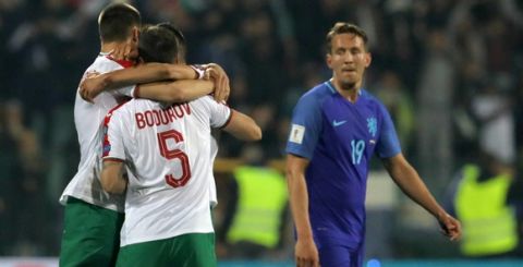 Bulgarian players, left, celebrate after their World Cup Group A qualifying soccer match against Netherlands, at the Vassil Levski stadium in Sofia, Bulgaria, Saturday, March 25, 2017. (AP Photo/Vadim Ghirda)
