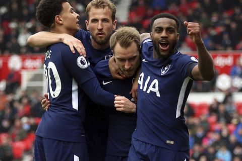Tottenham Hotspur's Christian Eriksen, center, celebrates scoring his side's first goal of the game with his team-mates during the English Premier League soccer match between Stoke City and Tottenham Hotspur at the bet365 Stadium Stoke, England. Saturday, April 7, 2018, 2018. (Nigel French/PA via AP)