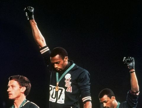 ** FILE ** Extending gloved hands skyward in racial protest, U.S. athletes Tommie Smith, center, and John Carlos stare downward during the playing of the Star Spangled Banner after Smith received the gold and Carlos the bronze for the 200 meter run at the Summer Olympic Games in Mexico City on Oct. 16, 1968. Australian silver medalist Peter Norman is at left. Peter Norman, the Australian who stood alongside the U.S. athletes staging the civil rights protest from the medal podium at the 1968 Olympics, died Tuesday October 3, 2006, of a heart attack. He was 64. (AP Photo/FILE)