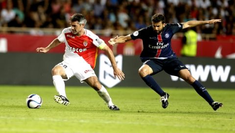 Monaco player Jeremy Toulalan, left, challenges for the ball with PSG player Thiago Motta during their French League One soccer match, in Monaco stadium, Sunday, Aug. 30, 2015. (AP Photo/Lionel Cironneau)
