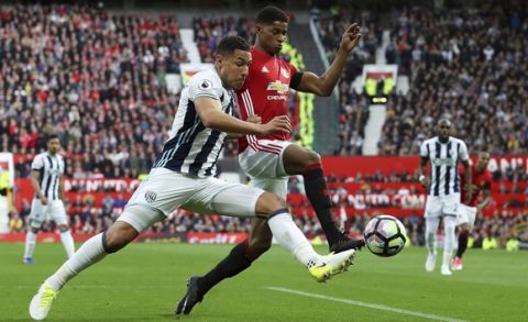 West Bromwich Albion's Jake Livermore, left, and Manchester United's Marcus Rashford in action during their English Premier League soccer match at Old Trafford in Manchester, England, Saturday April 1, 2017. (Martin Rickett/PA via AP)