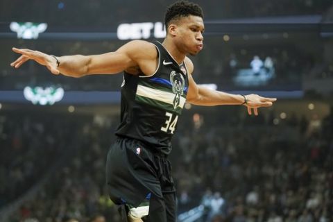 Milwaukee Bucks' Giannis Antetokounmpo stretches during the first half of an NBA basketball game against the Los Angeles Lakers Thursday, Dec. 19, 2019, in Milwaukee. (AP Photo/Morry Gash)