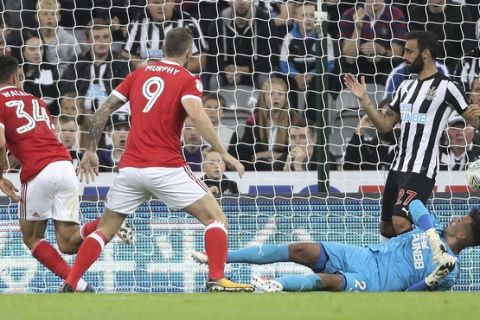 Nottingham Forest's Tyler Walker, left, scores against Newcastle United during the English League Cup second round match at St James' Park, Newcastle, England, Wednesday Aug. 23, 2017. (Owen Humphreys/PA via AP)