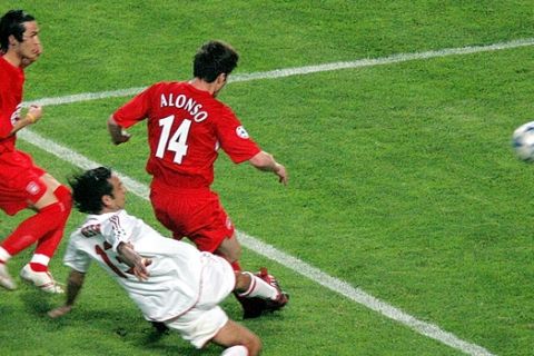Liverpool's Xabi Alonso, 14, slips past AC Milan defender Al,essandro Nesta to score his team's third goal during the UEFA Champions League Final between AC Milan and Liverpool at the Ataturk Olympic Stadium in  Istanbul, Turkey,Wednesday May 25, 2005. At left is Liverpool's Luis Garcia.(AP Photo/Murad Sezer)