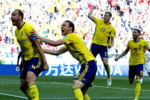 Sweden's Andreas Granqvist, left, celebrates after scoring the opening goal during the group F match between Sweden and South Korea at the 2018 soccer World Cup in the Nizhny Novgorod stadium in Nizhny Novgorod, Russia, Monday, June 18, 2018. (AP Photo/Pavel Golovkin)