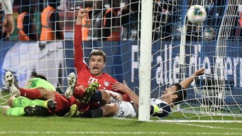 Bayern's Thomas Mueller, center, celebrates after scoring his side's second goal during the German soccer cup, DFB Pokal, second round match between VfL Bochum and Bayern Munich at the Vonovia Ruhrstadion stadium, in Bochum, Germany, Tuesday, Oct. 29, 2019. (AP Photo/Martin Meissner)