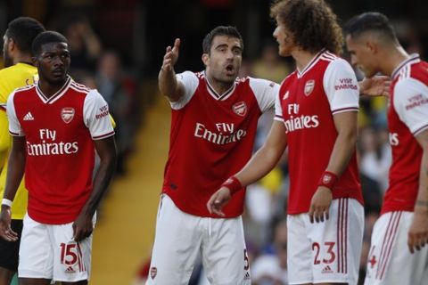 Arsenal's Sokratis Papastathopoulos, center, gestures as he shouts at his teammates during their English Premier League soccer match between Watford and Arsenal at the Vicarage Road stadium in Watford near London, Sunday, Sept. 15, 2019. (AP Photo/Alastair Grant)