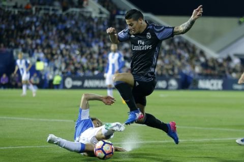 Real Madrid's James Rodriguez, top, vies for the ball with Leganes' Martin Mantovani during a Spanish La Liga soccer match between Leganes and Real Madrid at the Butarque stadium in Madrid, Wednesday, April 5, 2017. (AP Photo/Francisco Seco)