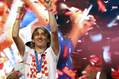 Croatia's player Luka Modric celebrates upon arrival in Zagreb, Croatia, Monday, July 16, 2018. Euphoria gave way to a mixture of disappointment and pride for Croatia fans after their national team lost to France in its first ever World Cup final. (AP Photo/Darko Vojinovic)